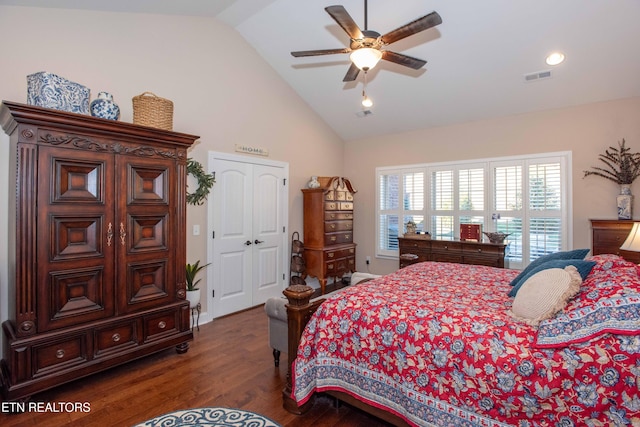 bedroom with dark wood-style floors, visible vents, vaulted ceiling, and ceiling fan