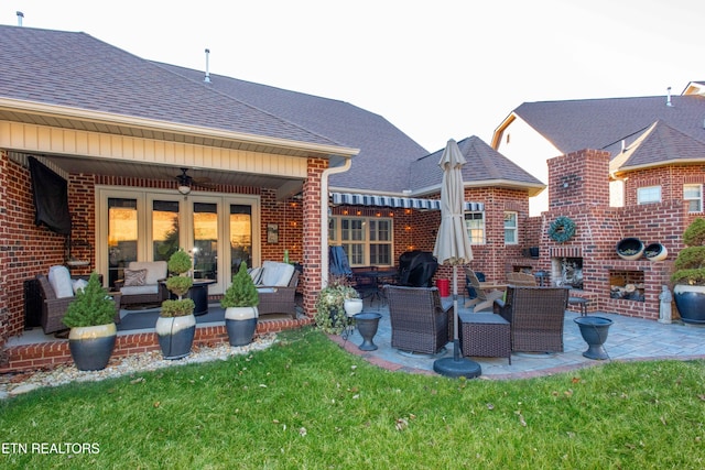 back of house featuring brick siding and an outdoor living space