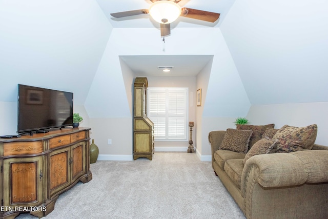 living room with light colored carpet, vaulted ceiling, and baseboards