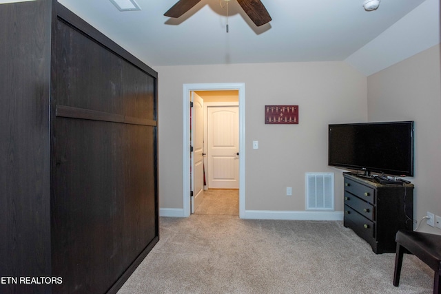 bedroom with light colored carpet, visible vents, vaulted ceiling, ceiling fan, and baseboards