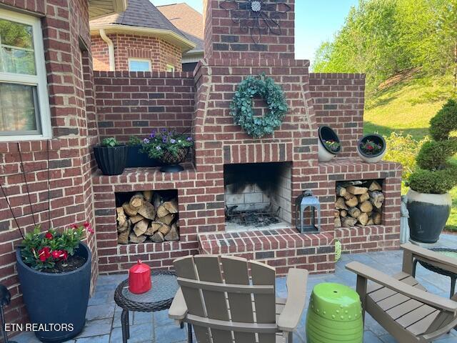 view of patio / terrace with an outdoor brick fireplace