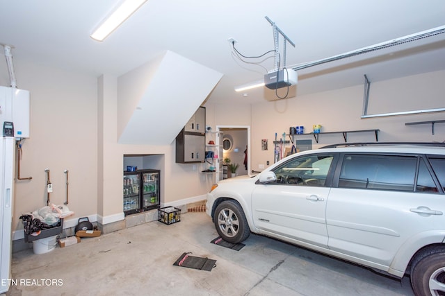 garage with water heater, baseboards, and a garage door opener