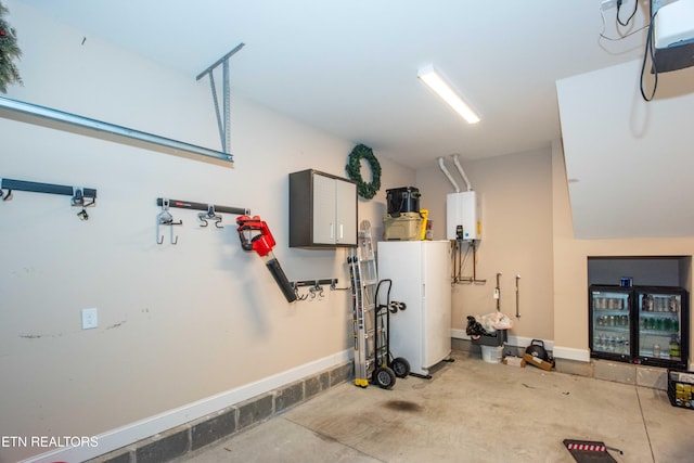 garage featuring water heater and baseboards