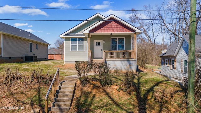 view of front of home featuring central AC, a porch, and stairway