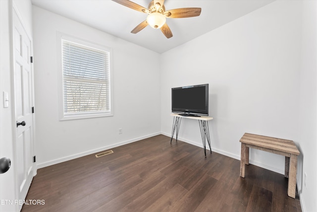 interior space featuring visible vents, ceiling fan, baseboards, and wood finished floors