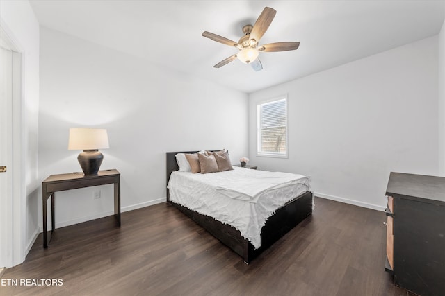 bedroom with dark wood-style floors, ceiling fan, and baseboards