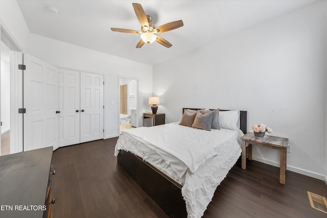 bedroom with dark wood finished floors, a closet, visible vents, ceiling fan, and baseboards