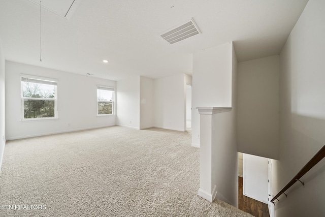 carpeted spare room featuring visible vents, recessed lighting, attic access, and baseboards