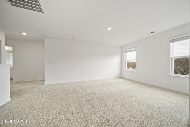 unfurnished room with baseboards, recessed lighting, visible vents, and light colored carpet