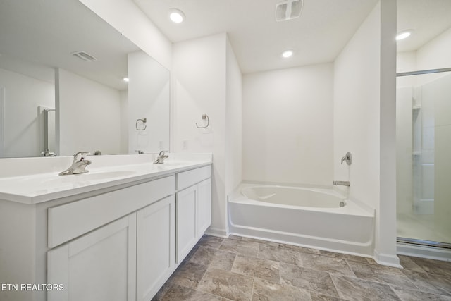 bathroom with double vanity, visible vents, walk in shower, and a sink