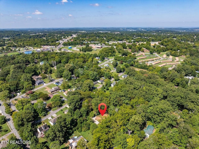 birds eye view of property with a view of trees