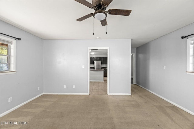 unfurnished bedroom featuring carpet flooring, ceiling fan, and baseboards