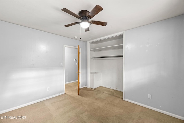 unfurnished bedroom with carpet, a closet, ceiling fan, and baseboards