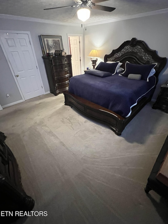 bedroom with a ceiling fan, baseboards, ornamental molding, and carpet flooring