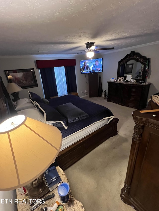 carpeted bedroom with a textured ceiling and a ceiling fan