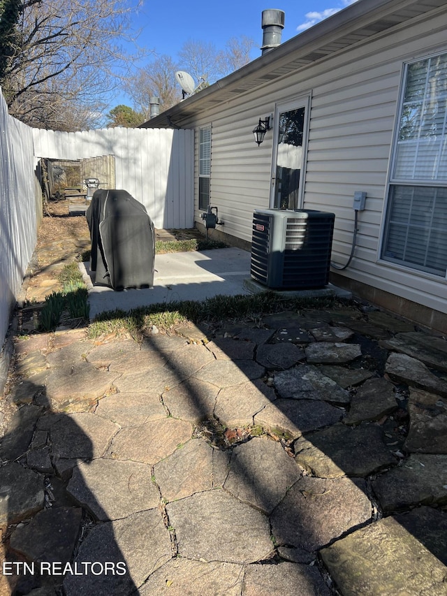 exterior space with fence private yard and central AC