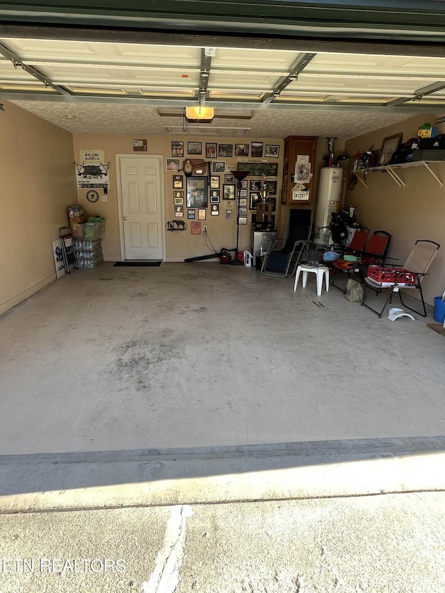 garage with water heater and a garage door opener