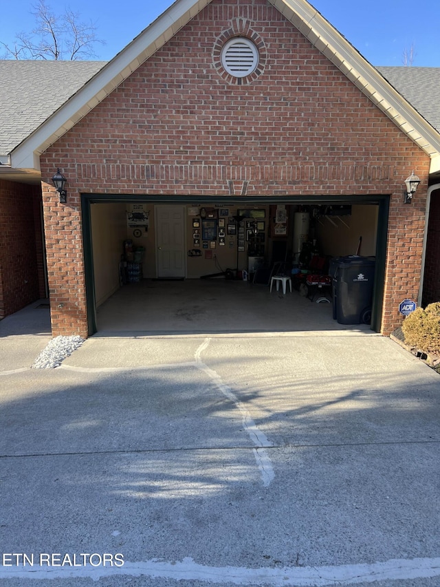 garage featuring concrete driveway