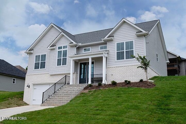 view of front facade featuring a garage, brick siding, and a front yard