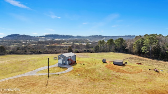 aerial view with a forest view, a mountain view, and a rural view