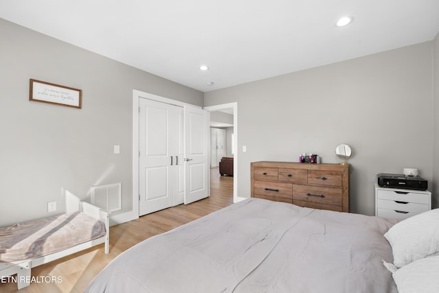 bedroom with wood finished floors, visible vents, and recessed lighting