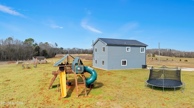 view of jungle gym with a yard and a trampoline