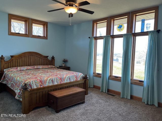 bedroom featuring carpet, multiple windows, visible vents, and baseboards