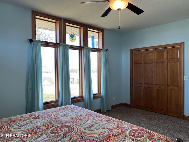 bedroom with carpet floors, ceiling fan, and baseboards