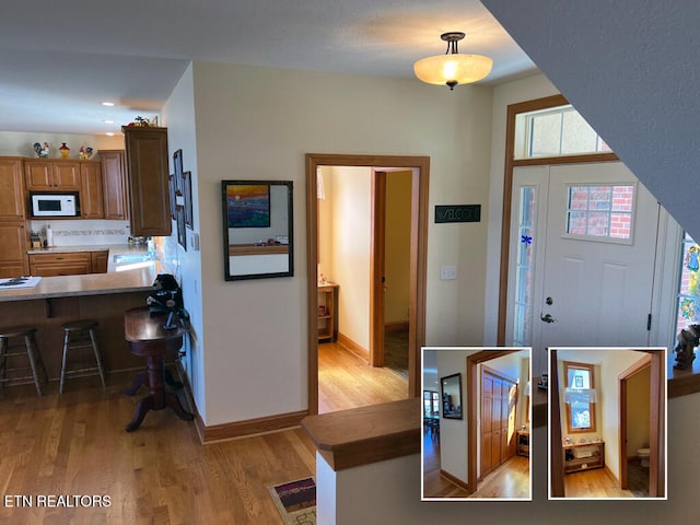 foyer featuring light wood finished floors, recessed lighting, and baseboards