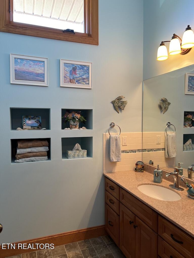 bathroom featuring baseboards and vanity