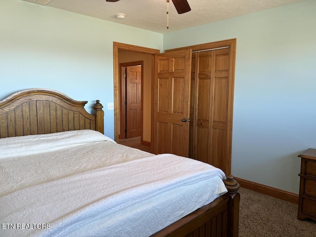 carpeted bedroom with ceiling fan, a textured ceiling, baseboards, and a closet