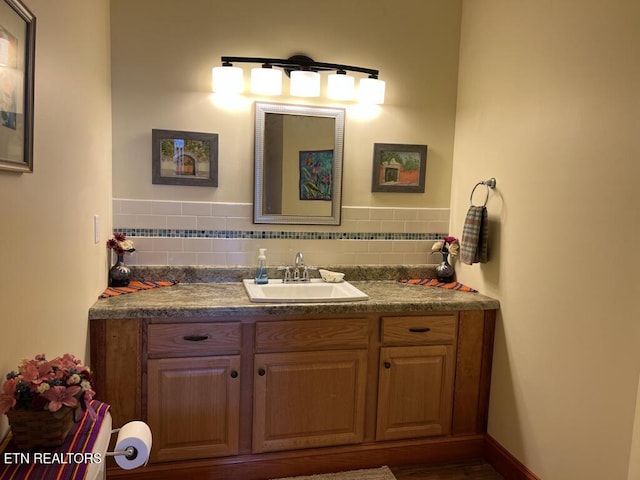 bathroom featuring tasteful backsplash and vanity