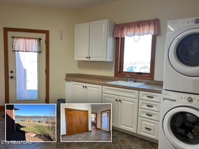 laundry room featuring stone finish floor, cabinet space, a sink, and stacked washing maching and dryer