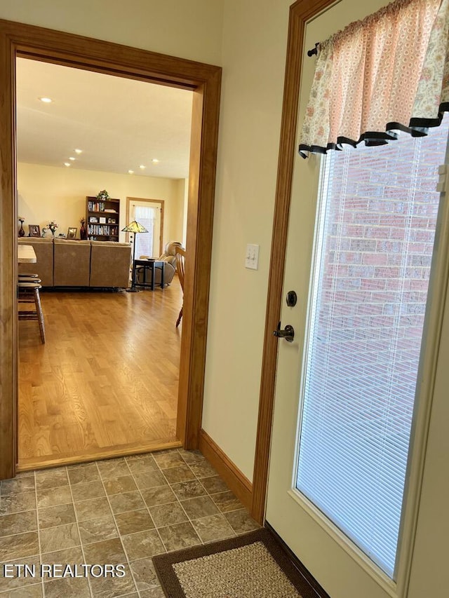 entryway with recessed lighting and baseboards