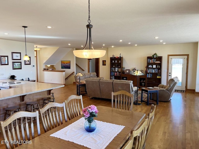 dining space featuring wood finished floors and recessed lighting