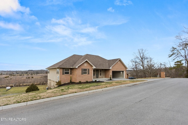 ranch-style home featuring brick siding, roof with shingles, concrete driveway, an attached garage, and a front lawn