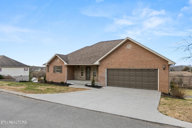 single story home with a garage, concrete driveway, and brick siding