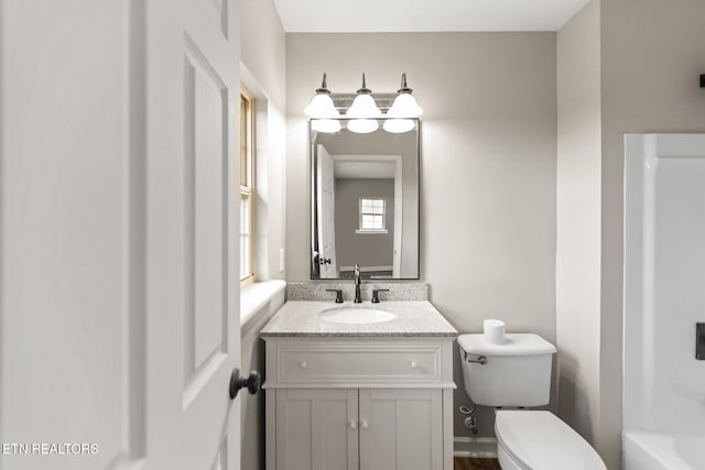 full bathroom featuring a bathtub, vanity, and toilet