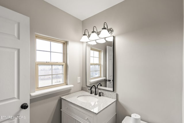 half bathroom featuring toilet and vanity