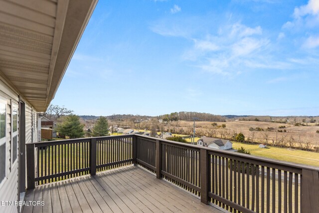 wooden deck with a lawn