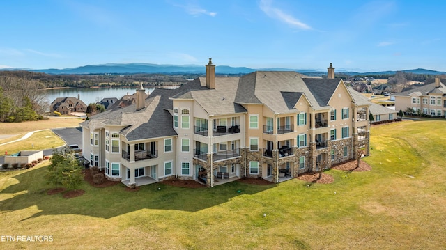 birds eye view of property featuring a residential view and a water and mountain view