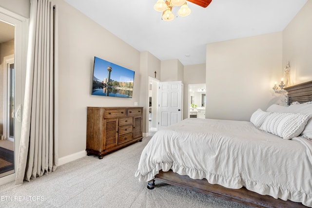 bedroom with carpet floors, ensuite bath, and baseboards