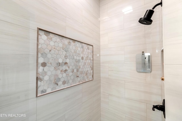 full bathroom with a tile shower