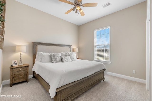 bedroom featuring visible vents, ceiling fan, light carpet, and baseboards