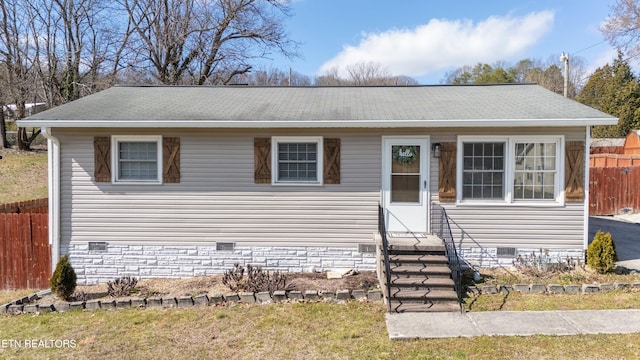 view of front of property featuring crawl space, a shingled roof, fence, and entry steps