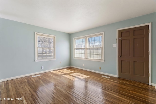 foyer with visible vents, baseboards, and wood finished floors