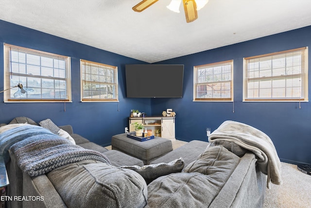 living area with a ceiling fan, carpet flooring, and baseboards