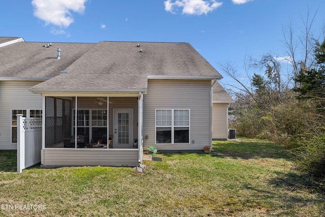 back of property with central AC, roof with shingles, a yard, and a sunroom