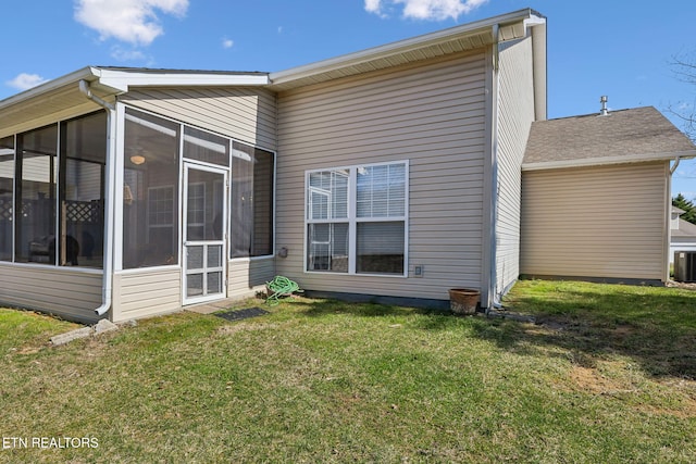 back of house with a yard, cooling unit, and a sunroom