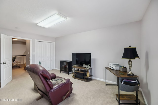 living area featuring baseboards and light colored carpet